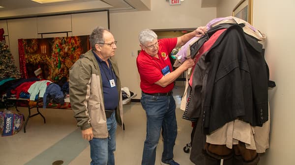Council members sorting coats for children in the community