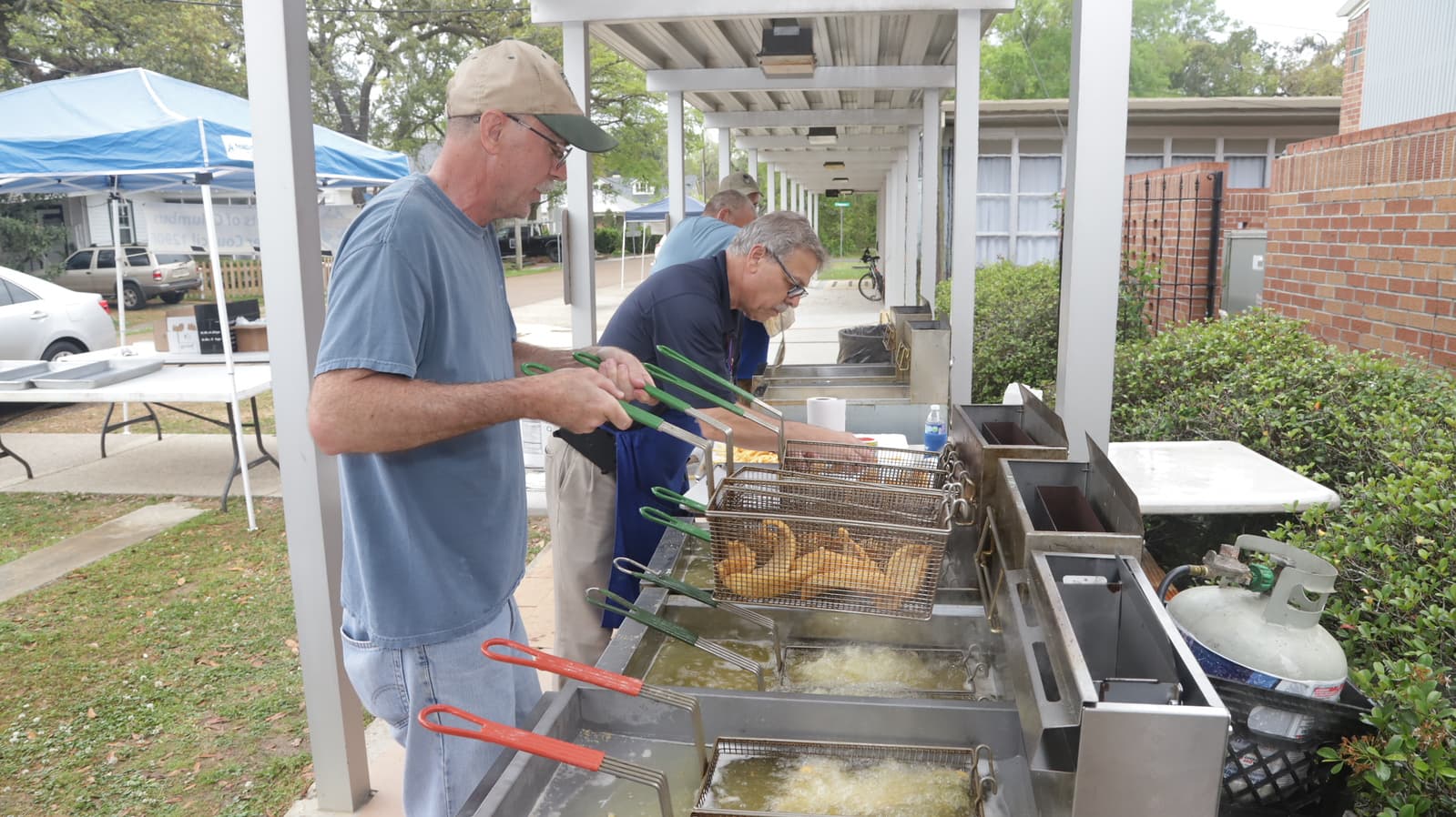 Council 12906 members cooking food for a parish fish fry