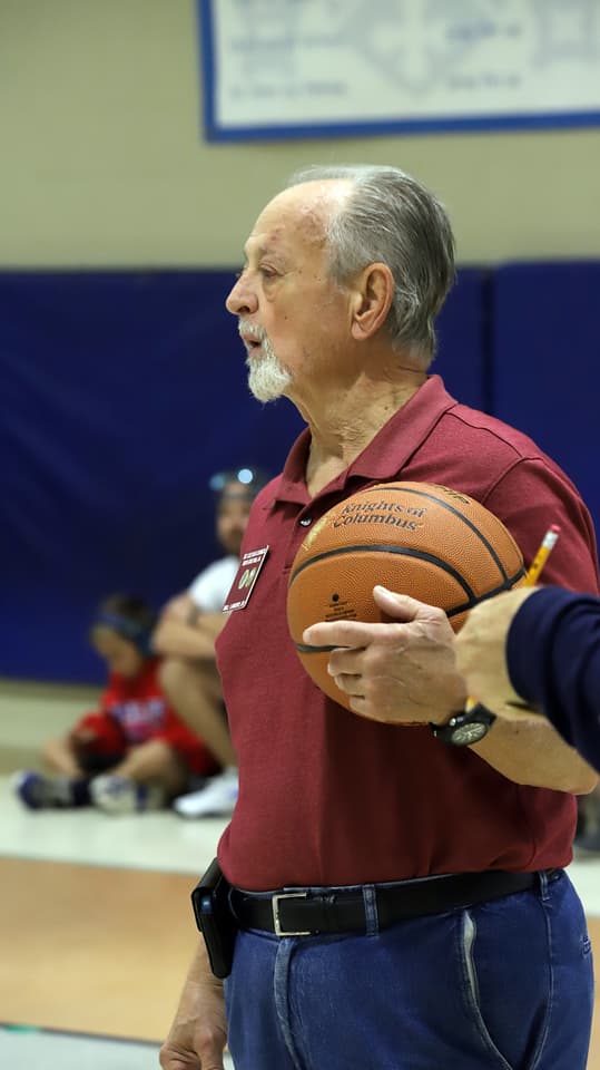 A volunteer holding a basketball during the free throw contest